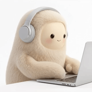 Jolly wearing headphones and working on a laptop